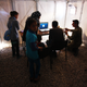 Major Morfidis of the Greek army helps a family at Diavata use Skype to apply for asylum.